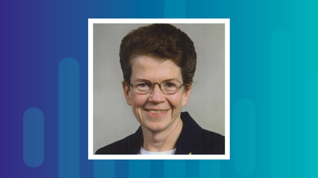 Sr. Maureen McGuire, who has short brown hair, wire rimmed glasses, blue eyes and a friendly smile.